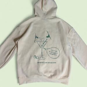 Rebellious Ski Club cream hoodie with green graphic of a martini glass - size M